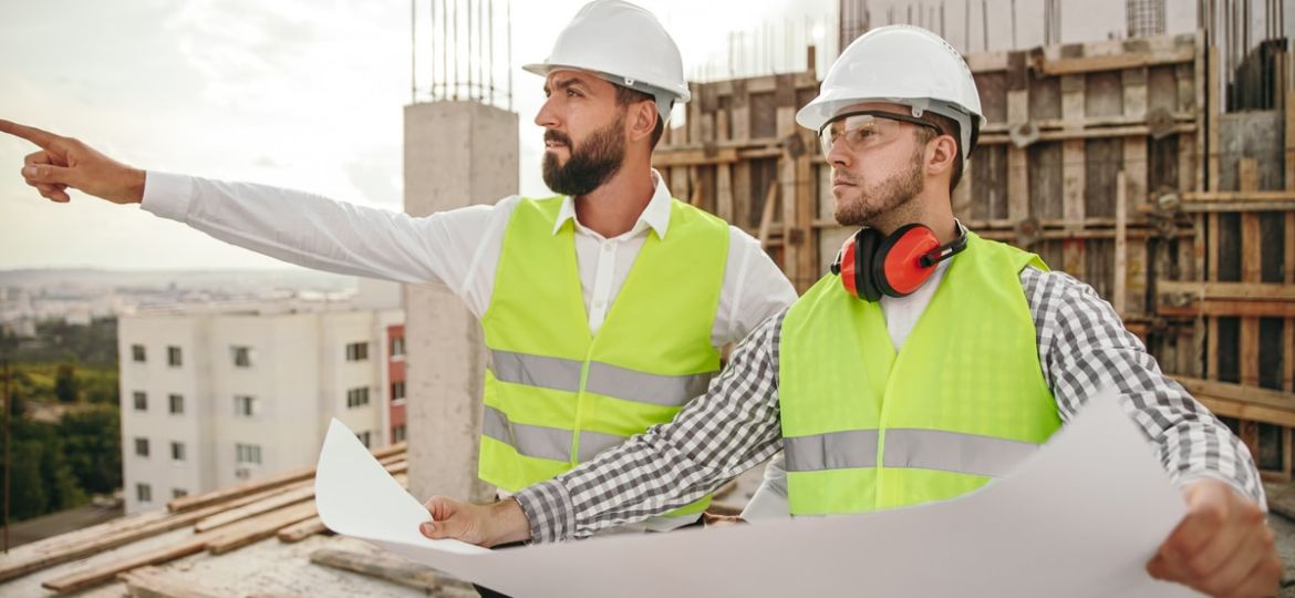 Supervisor with colleague discussing construction project