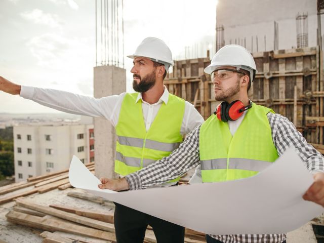 Supervisor with colleague discussing construction project